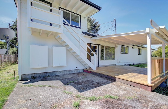 rear view of house featuring a deck