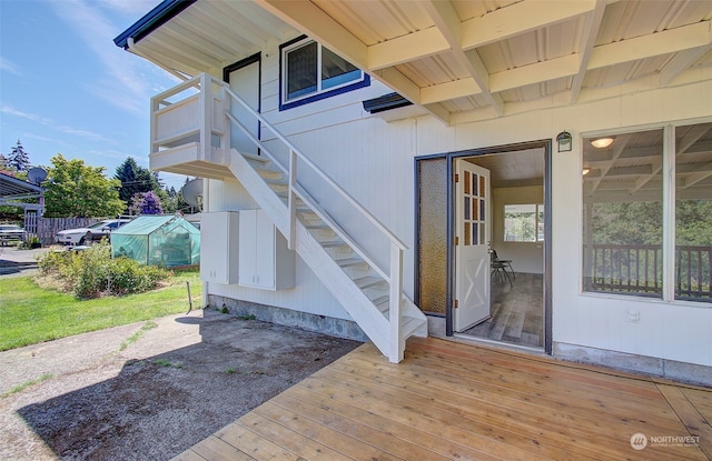 view of exterior entry featuring a deck