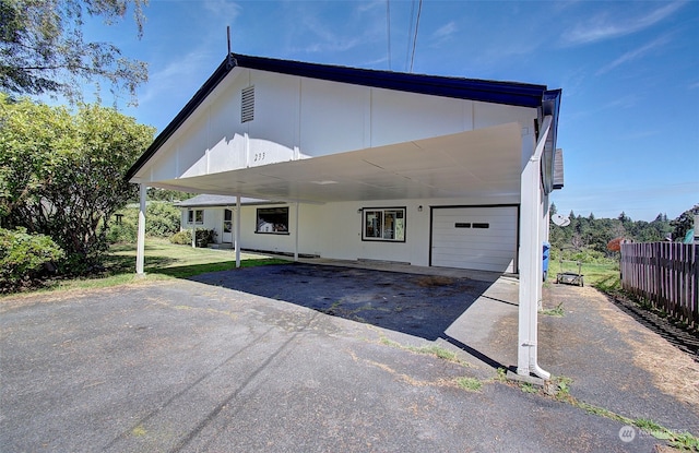 back of house with a carport