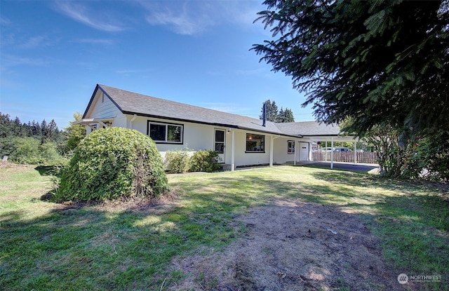 single story home with a carport and a front lawn