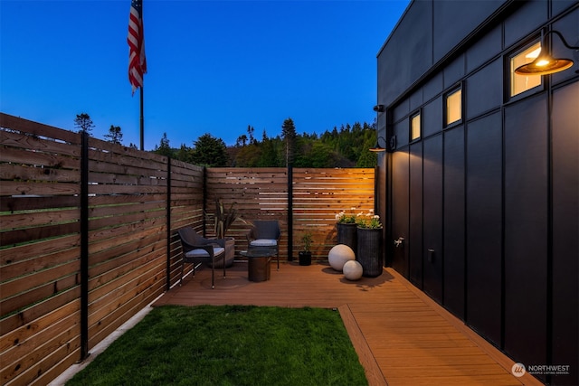 patio terrace at dusk featuring a deck