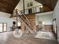 stairway featuring wood ceiling, high vaulted ceiling, and wood-type flooring