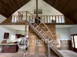 stairway featuring a wealth of natural light, high vaulted ceiling, and wood ceiling