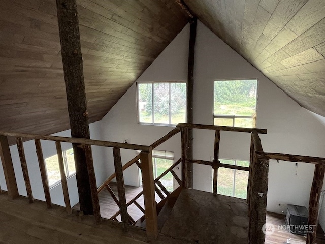 staircase featuring wooden ceiling, lofted ceiling, and hardwood / wood-style floors