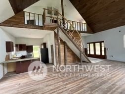 living room featuring french doors, hardwood / wood-style floors, and a high ceiling