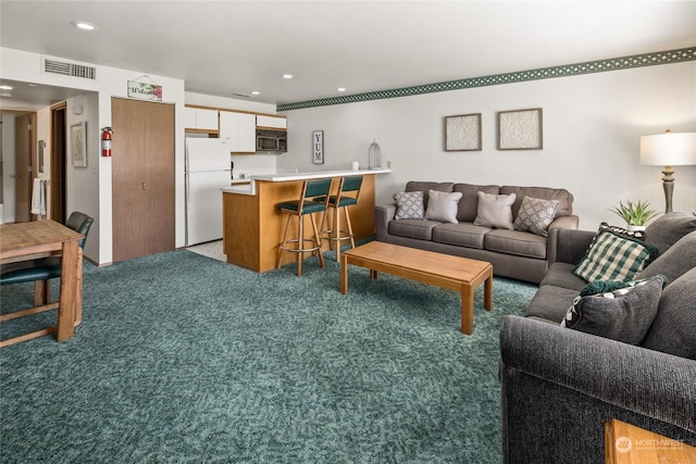 living room featuring light carpet, recessed lighting, and visible vents