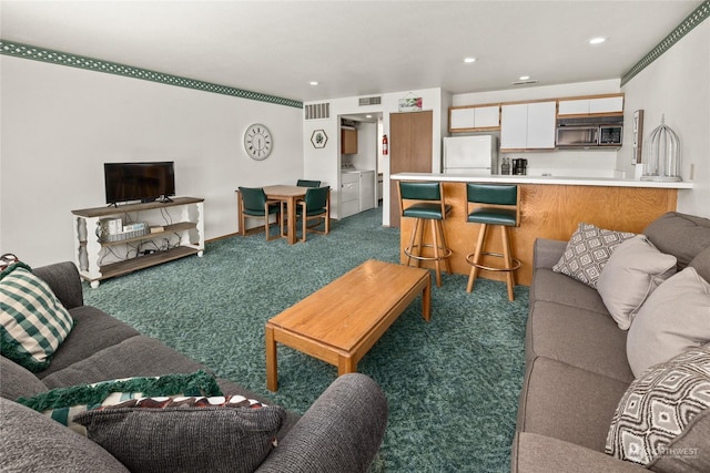 living area with dark carpet, washer and clothes dryer, recessed lighting, and visible vents