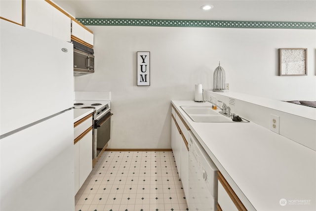 kitchen with sink, white cabinetry, white appliances, and light tile patterned floors