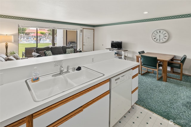 kitchen featuring light carpet, dishwasher, white cabinets, and sink