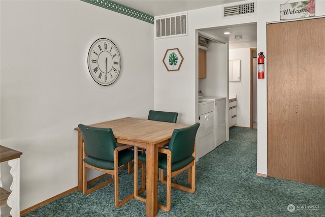 carpeted dining room featuring washing machine and clothes dryer