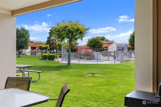 view of yard featuring fence and a residential view