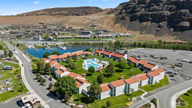 drone / aerial view featuring a water and mountain view