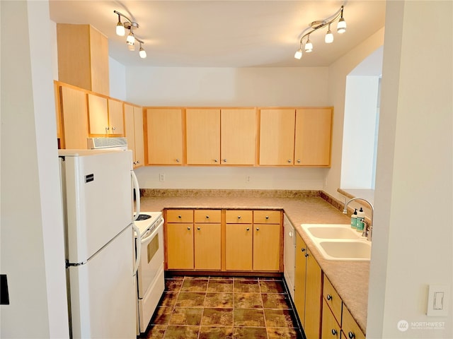 kitchen with light brown cabinets, white appliances, and sink