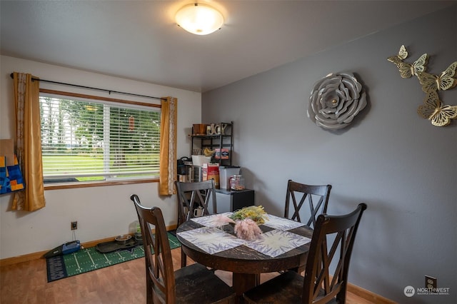 dining space with hardwood / wood-style floors