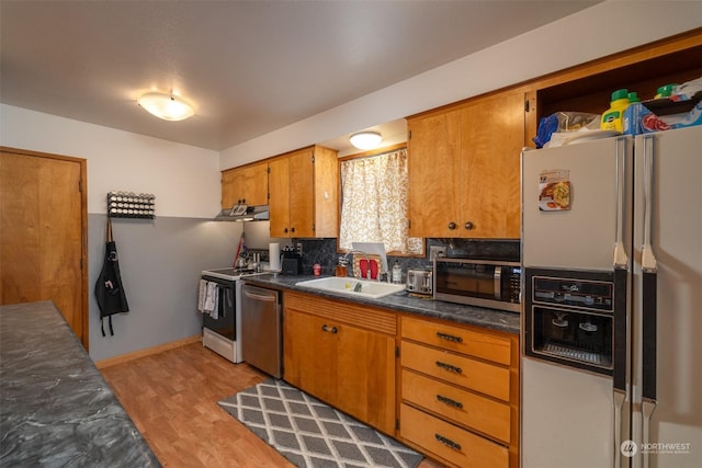 kitchen featuring sink, light hardwood / wood-style floors, and appliances with stainless steel finishes