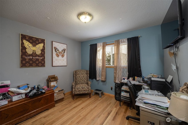 office with a textured ceiling and light hardwood / wood-style flooring