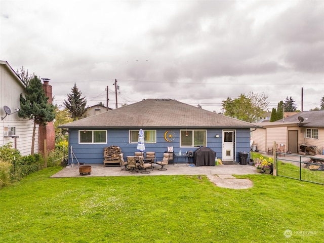 back of house featuring a lawn and a patio area