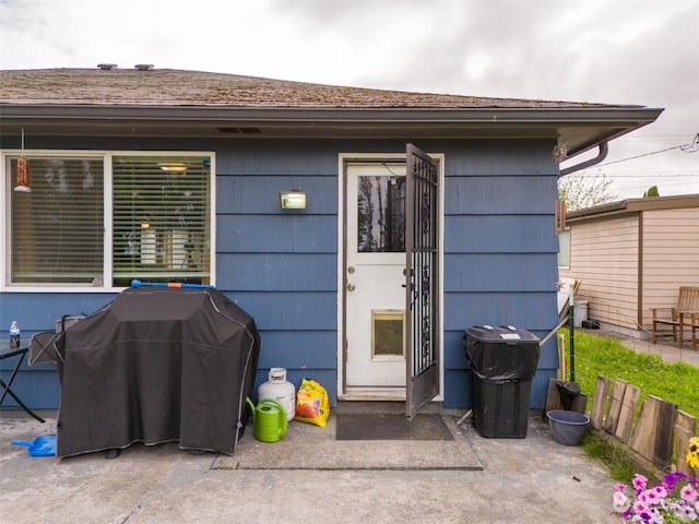 view of exterior entry featuring a patio