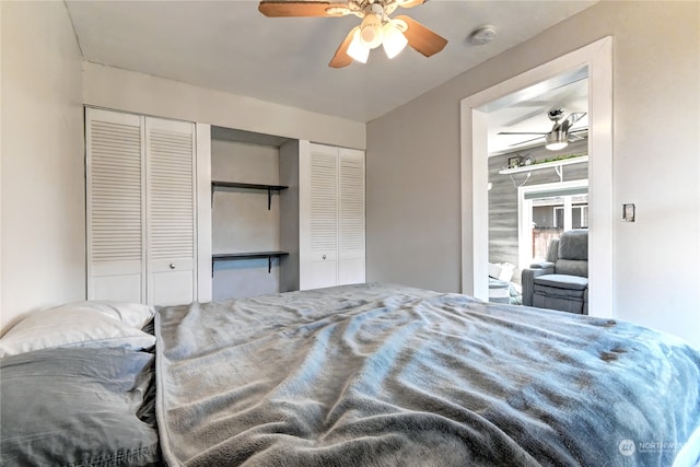 bedroom with ceiling fan and two closets