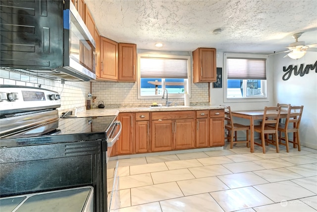 kitchen with ceiling fan, stainless steel appliances, sink, and plenty of natural light