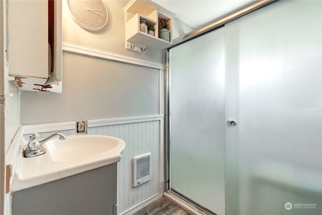 bathroom with vanity, walk in shower, and wood-type flooring