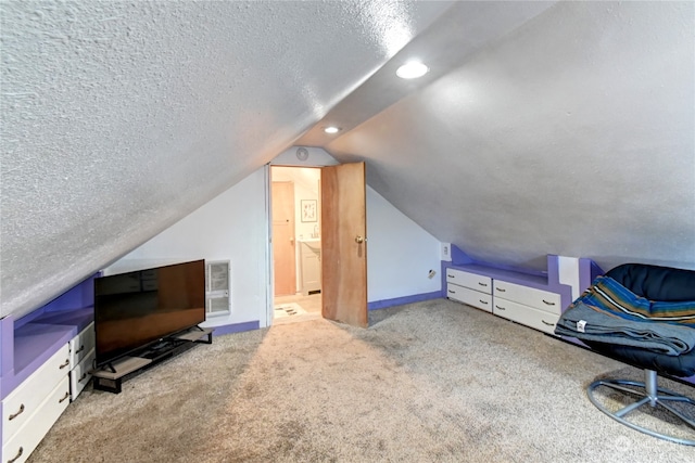 bonus room with a textured ceiling, vaulted ceiling, and light colored carpet