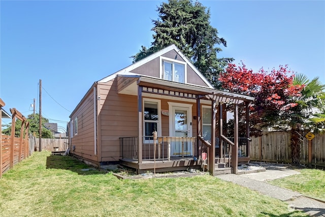 bungalow featuring a front lawn and covered porch