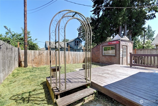 deck with an outbuilding and a lawn