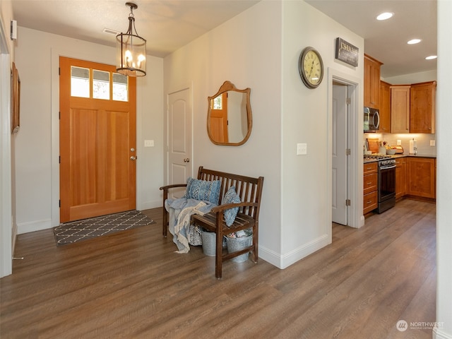 foyer featuring a notable chandelier and hardwood / wood-style floors