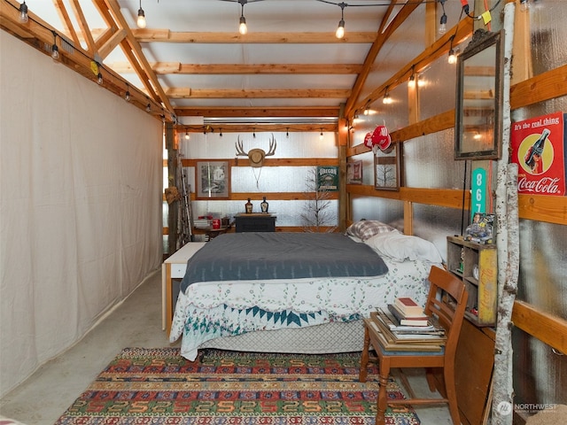 bedroom with vaulted ceiling with beams and concrete floors