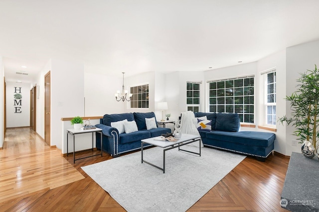 living room featuring wood-type flooring and an inviting chandelier