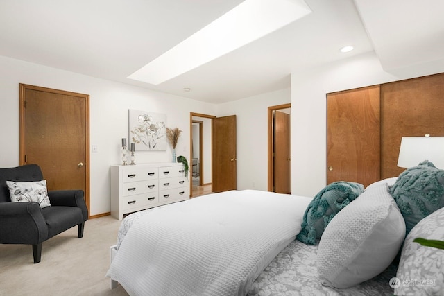 bedroom featuring light carpet and a skylight