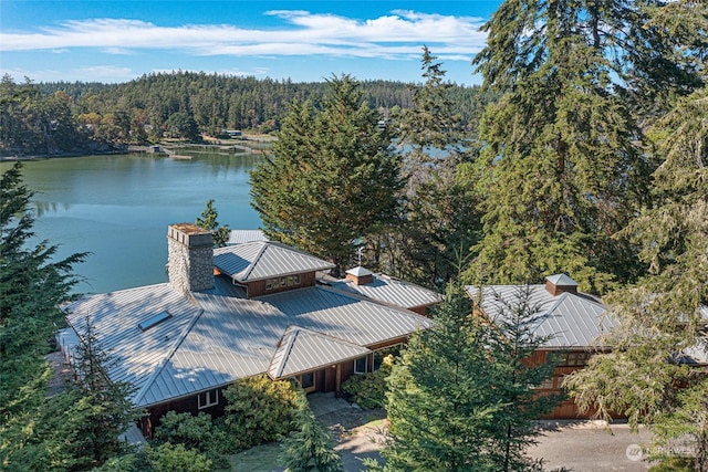 birds eye view of property with a water view and a wooded view