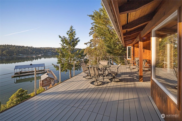 wooden terrace featuring a water view