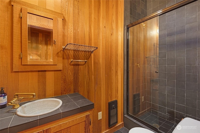 bathroom featuring toilet, a stall shower, and vanity