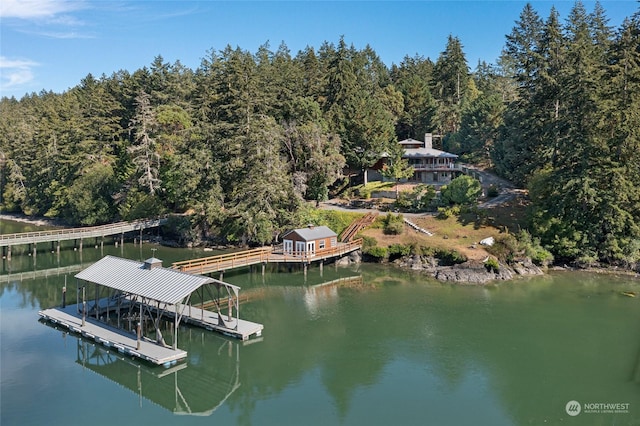 view of dock featuring a water view and a wooded view