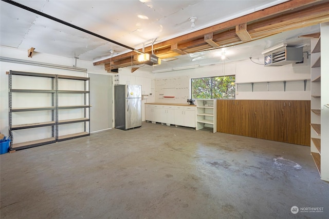 garage with a garage door opener and freestanding refrigerator