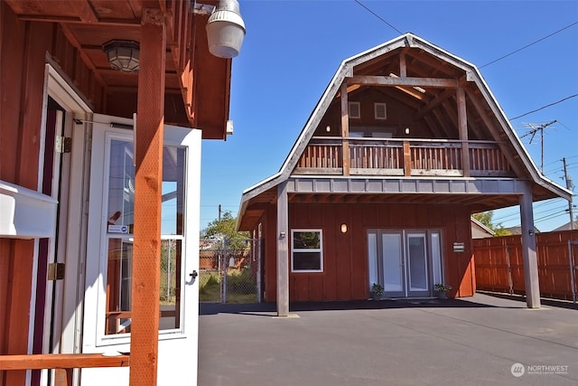 back of property with a balcony and a patio