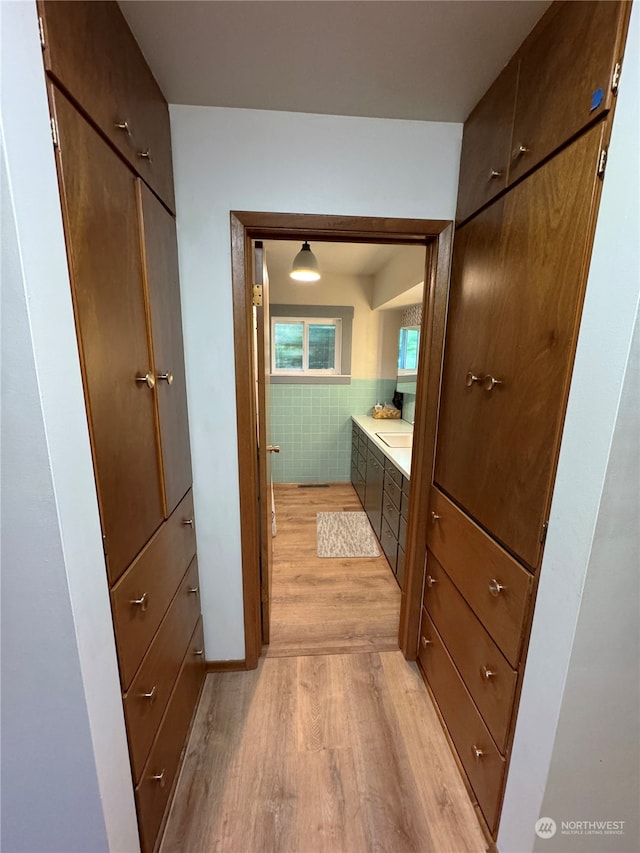 hall featuring sink and light wood-type flooring