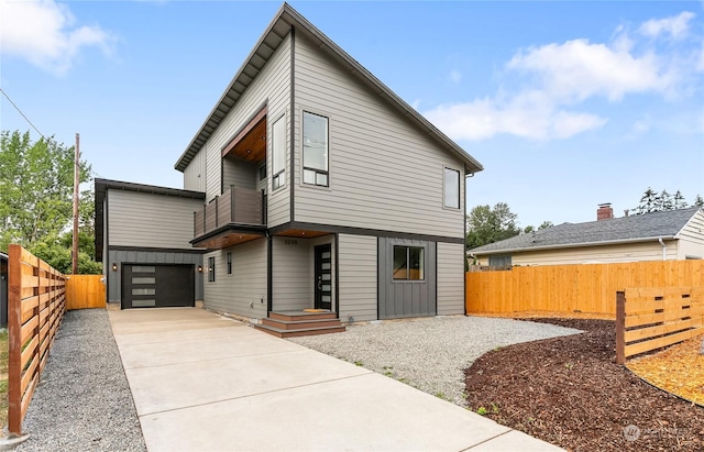 rear view of property with a garage