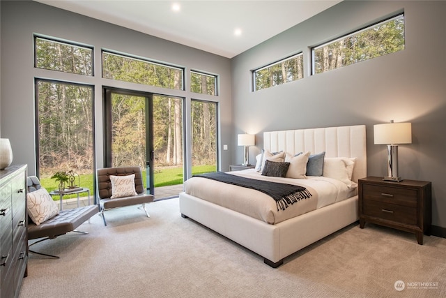 bedroom with access to exterior, recessed lighting, and light colored carpet