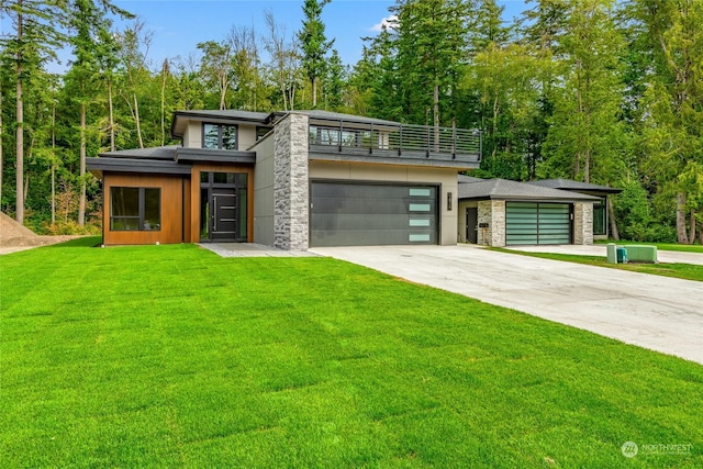 view of front facade featuring stone siding, a balcony, an attached garage, concrete driveway, and a front lawn