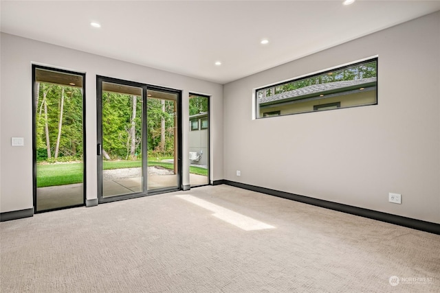 carpeted spare room with baseboards and recessed lighting