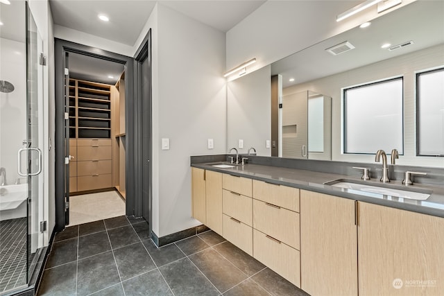 bathroom with double vanity and tile patterned flooring