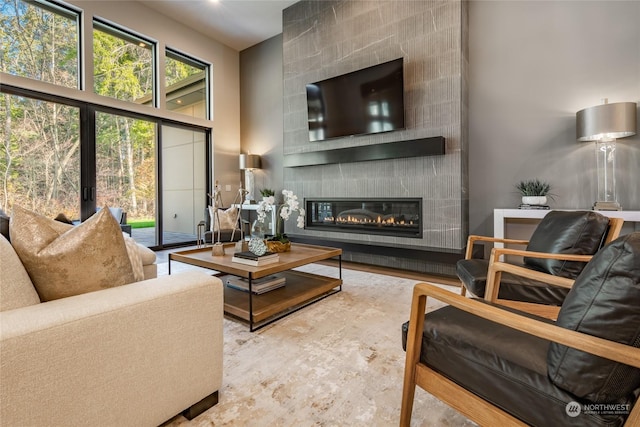 living room with a large fireplace and a high ceiling