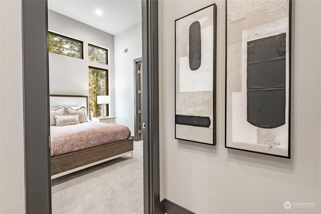 carpeted bedroom featuring visible vents