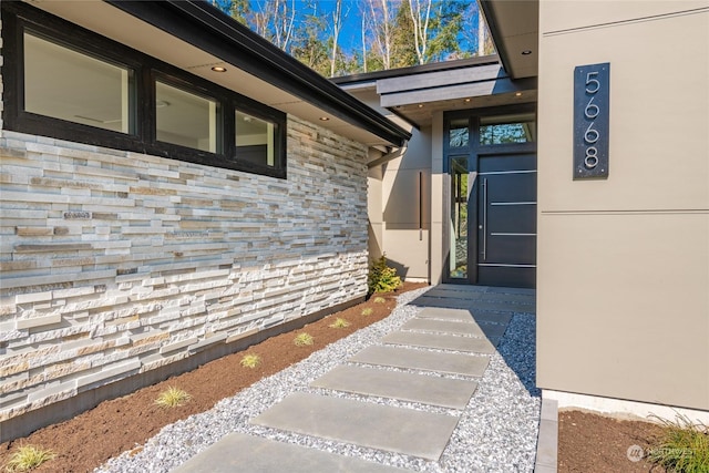 entrance to property featuring stone siding