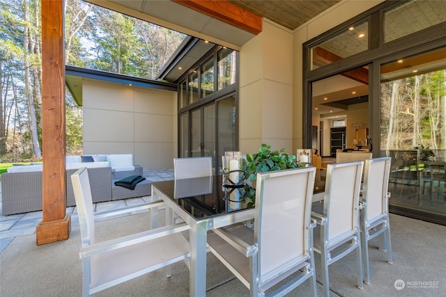 sunroom featuring wooden ceiling and a healthy amount of sunlight