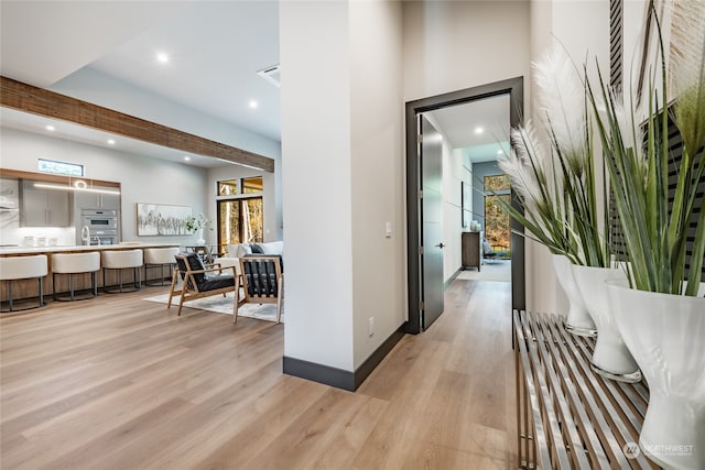 corridor with light hardwood / wood-style floors