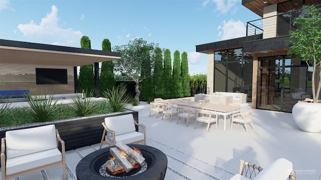 view of patio with a balcony and an outdoor fire pit